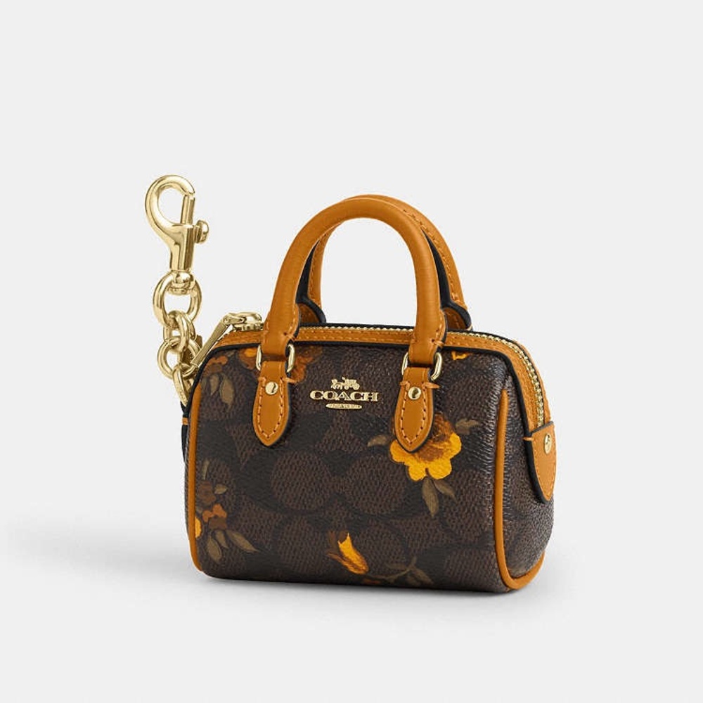 Coach Mini Rowan Bag Charm In Signature Canvas With Floral Print in Walnut/Yello